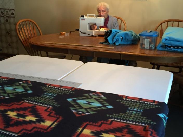 My Mom, sewing an Encouragement Blanket.