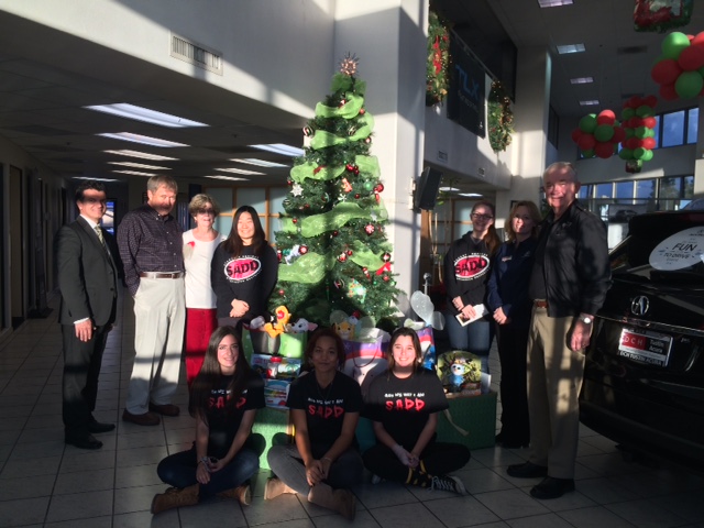 Girls are SADD volunteers who have collected app 200 toys  Tree