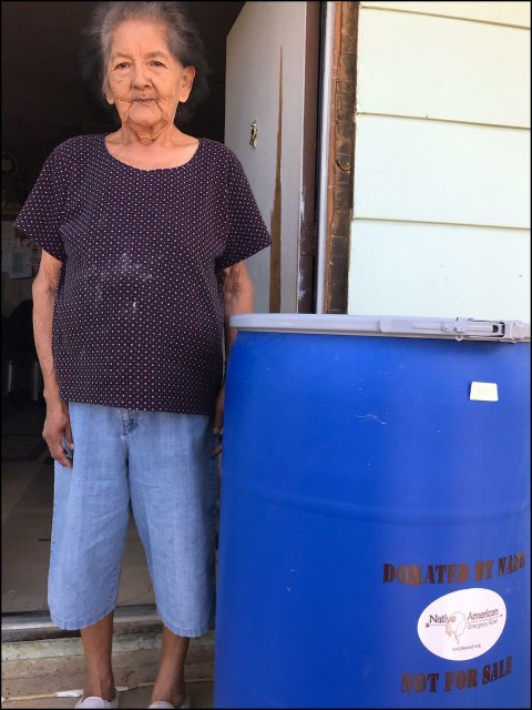 PHOTOS OF MEN WITH WATER BARREL AND WOMAN WITH WATER BARREL